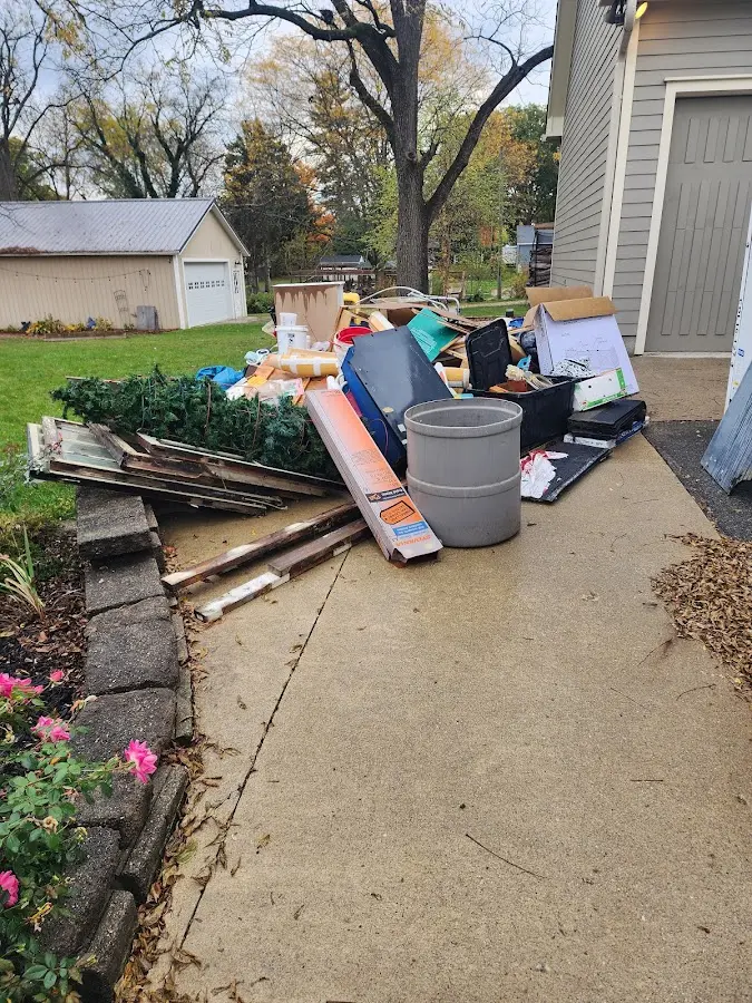 Dumpster being loaded with debris for Commercial Dumpster Rental in Hanford
